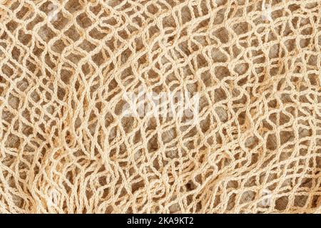 Natural background of mesh string reusable knitted bag. Concept of zero waste, recycling, ecology Stock Photo