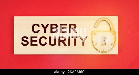 Business concept. On a red background there is a small plaque on it with a lock and an inscription -CYBER SECURITY Stock Photo