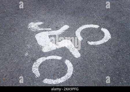 Image of a sign in the shape of a motorcycle painted on the asphalt in a parking lot Stock Photo