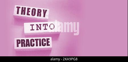 Theory into practice words written on wooden blocks. Education or business startup concept Stock Photo