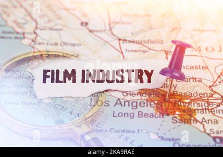 Business and industry concept. On the map, indicated by the Los Angeles button, next to it lies a magnifying glass and a piece of paper with the inscr Stock Photo