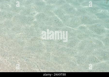 Soft blue sea wave on clean sandy beach. Stock Photo