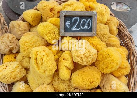 Yellow natural cleaning sponge in the store with price. Stock Photo