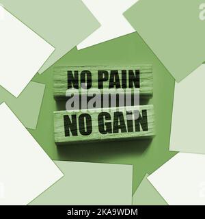 No Pain No Gain message written with wooden blocks on yellow. Business success concept. Stock Photo