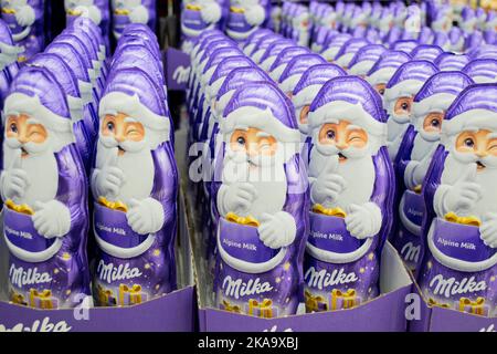 Moscow, Russia, November 2020: Close up of lots of chocolate winking Santa Claus Milka in purple. Stock Photo