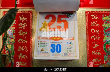 Moscow, Russia, November 2019: Detachable tear-off Vietnamese calendar with date December 25, 2019 on the wall: red numbers, hieroglyphs, beautiful go Stock Photo