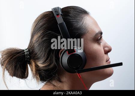 Online support woman operator side view isolated on studio background Stock Photo