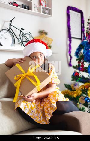 Little girl at home with gift from Santa Claus. Christmas time. Happy moments. Stock Photo