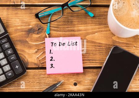 The business desk with pink paper and to-do list Stock Photo
