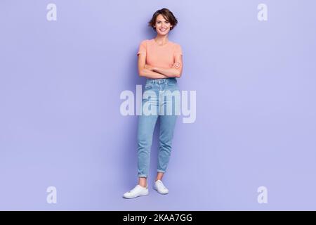 Full size photo of pretty cute with bob hairdo dressed striped t-shirt denim jeans hands crossed isolated on yellow color background Stock Photo