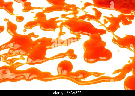 Orange sauce splashes isolated on white a background. Top view. Stock Photo