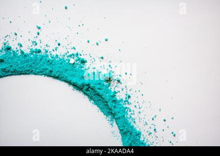 Turquoise colored powder whirlwind on white background Stock Photo