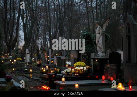 Warsaw, Poland. 01st Nov, 2022. A tomb decorated with a sculpture is seen on All Saints' Day at the Pow?zki Cemetery. All Saints' Day/All Souls' Day (or Dzie? Zaduszny in Polish) is a public holiday and an opportunity to remember the dead. On this day people take flowers and candles to cemeteries. In the darkness all the cemetery is full of lights. Pow?zki Cemetery (or Old Pow?zki) is a historic necropolis in Warsaw. It is the most famous cemetery in the city and one of the oldest. Credit: SOPA Images Limited/Alamy Live News Stock Photo