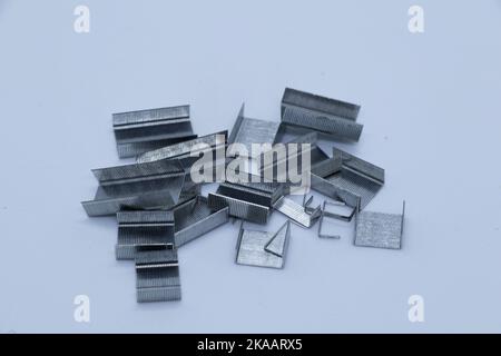Gray staples on white background Stock Photo