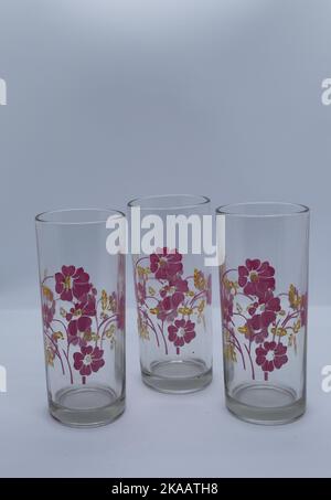 Glass cups with flower image on white background Stock Photo