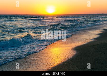 Sunrise on the Sea of Azov, sun and waves in the morning. Front view. Stock Photo