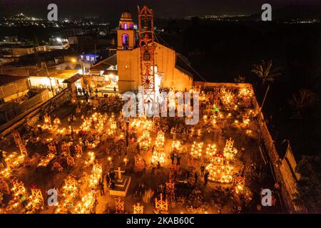 Morelia, Mexico, 1 Nov 2022, Day of the Dead celebration in the cemetery of Arocutin, Michoacan, Mexico. The indigenous Purepecha of this village prepare this annual ritual of remembrance by constructing altars with marigolds, candles and the favorite food or drink of the deceased.  The vigil takes place the night of November 1st and has become a major tourist attraction in the central Mexican state of Michoacan.  Brian Overcast/Alamy Live News Stock Photo