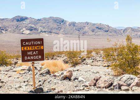 A road sign in Death Valley warning travelers of Caution Extreme Heat Danger Stock Photo