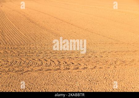 freshly plowed field in autumn with marks of tire Stock Photo