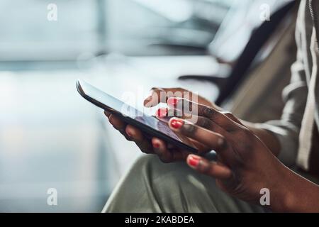 Checking for updates. an unrecognizable woman using her digital tablet. Stock Photo