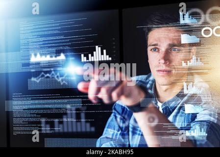 Touching the future. a handsome young male programmer at work. Stock Photo