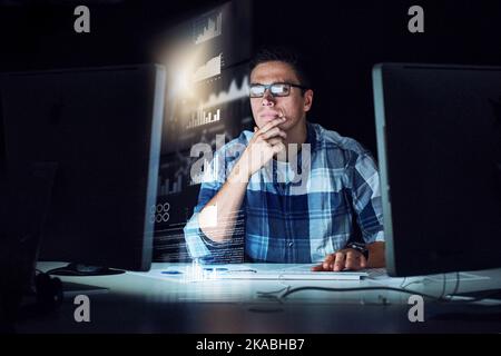 Carefully scouring through source code. a handsome young male programmer at work. Stock Photo