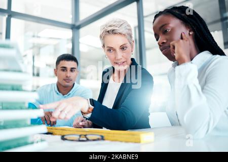 Architecture, meeting and architects working with a model, planning construction and strategy for industrial project. Creative, collaboration and Stock Photo