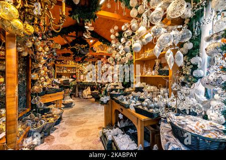 Different types of traditional handmade Christmas decorations on sale inside of small wooden shop in Vienna, Austria. Stock Photo