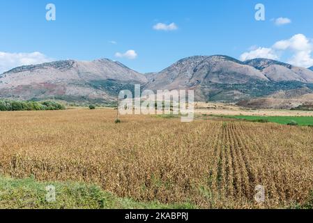 Idyllic valley landscape with agricultural fields surrounded by mountains in southern Albania
