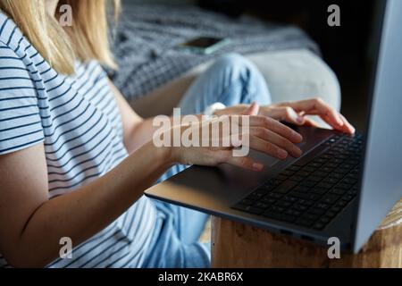 Working from home concept. Woman jands typing on laptop keyboard. Remote work from home workplace Stock Photo