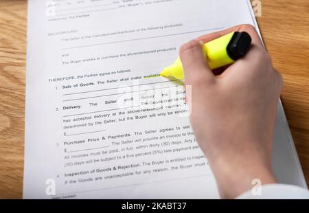 Hand reading contract and highlighting AVAILABLE word in agreement - Minsk, Belarus - November 10 2021. Stock Photo