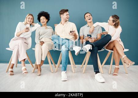 Hiring, phone and recruitment with people in a room waiting, laughing and bond before interview, relax and happy. Candidate, unemployed and group Stock Photo