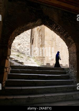 Woman walking through entrance gate at Ananuri Fortress, Georgia. High quality photo Stock Photo