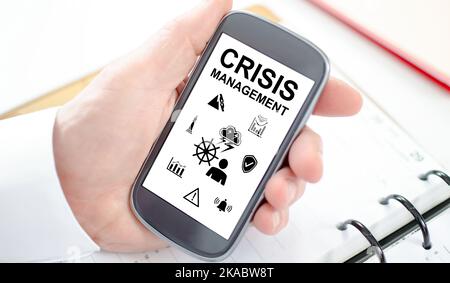 Crisis management concept shown on a smartphone screen Stock Photo