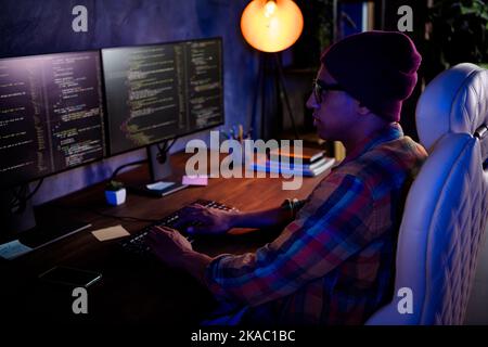 Profile portrait of professional web designer sit chair keyboard typing writing dark room office workplace Stock Photo