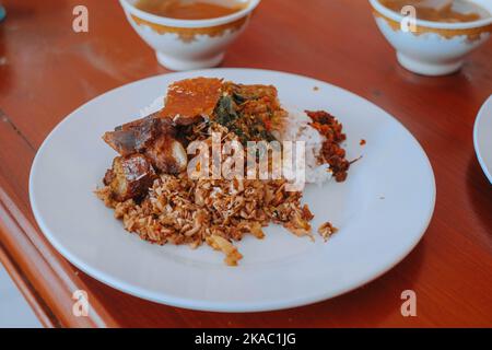 A plate of Nasi Babi Guling or Pork Roll Rice in English which typical Balinese food Stock Photo