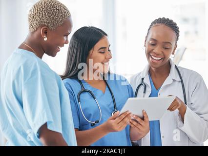 Doctor, team and tablet in collaboration with smile for research, healthcare or good news at the hospital. Happy medical professionals smiling in Stock Photo