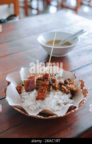 A plate of Nasi Babi Guling or Pork Roll Rice in English which typical Balinese food Stock Photo