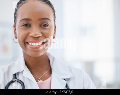 Black woman doctor, hospital and portrait of young, professional and medical cardiology expert staff working in clinic with mockup space. Happy female Stock Photo