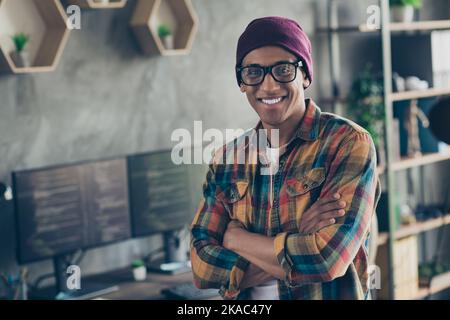 Photo of cheerful smart cybersecurity expert person crossed hands toothy smile office building indoors Stock Photo