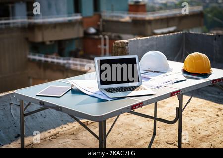 Concept of architects, engineer equipment on the desk with a blueprint in construction site. Stock Photo