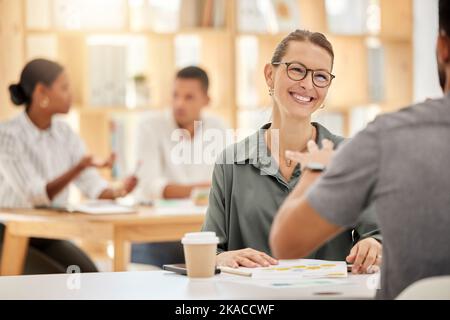 Collaboration, meeting and business people talking in the office with documents planning a project. Happy, smile and managers working on a report Stock Photo