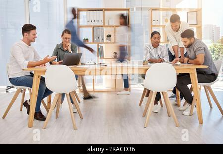 Busy office, team and coworking employee group planning a digital strategy at a desk. Teamwork, collaboration and online marketing workforce with Stock Photo