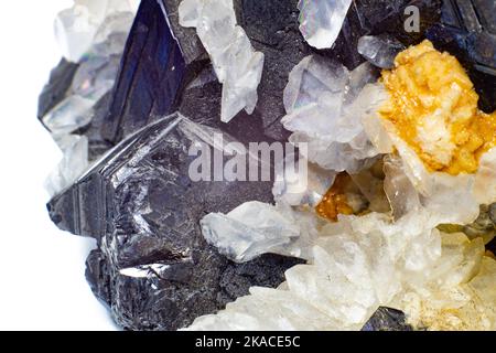 A crystal and stone cluster with clear white quartz, silver metallic pyrite and black matrix macro close up isolated on a white Stock Photo