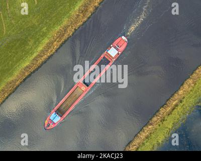 Moving Inland freight ship Aerial top down view  in dutch canal Stock Photo