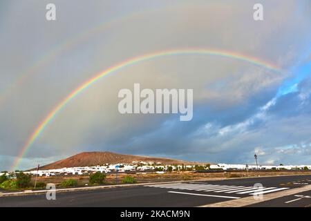 beautiful rainbow over the mountain with dark clouds Stock Photo