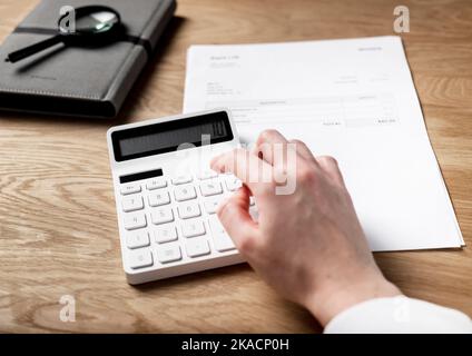 Business paper document and hand make calculations on calculator. Financial concept. Stock Photo