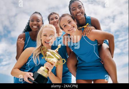 Women sports trophy, team portrait below and girl happiness smile for winning sport competition. Woman together happy, winner collaboration success Stock Photo