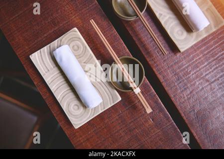 Japanese restaurant in traditional style, Empty plate on mat near chopstick bowl, Selective Focus Stock Photo