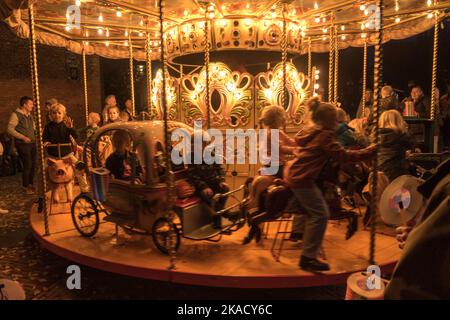 Enkhuizen, Netherlands. October 2022. An old-fashioned carousel with children at a fair in Enkhuizen. High quality photo Stock Photo